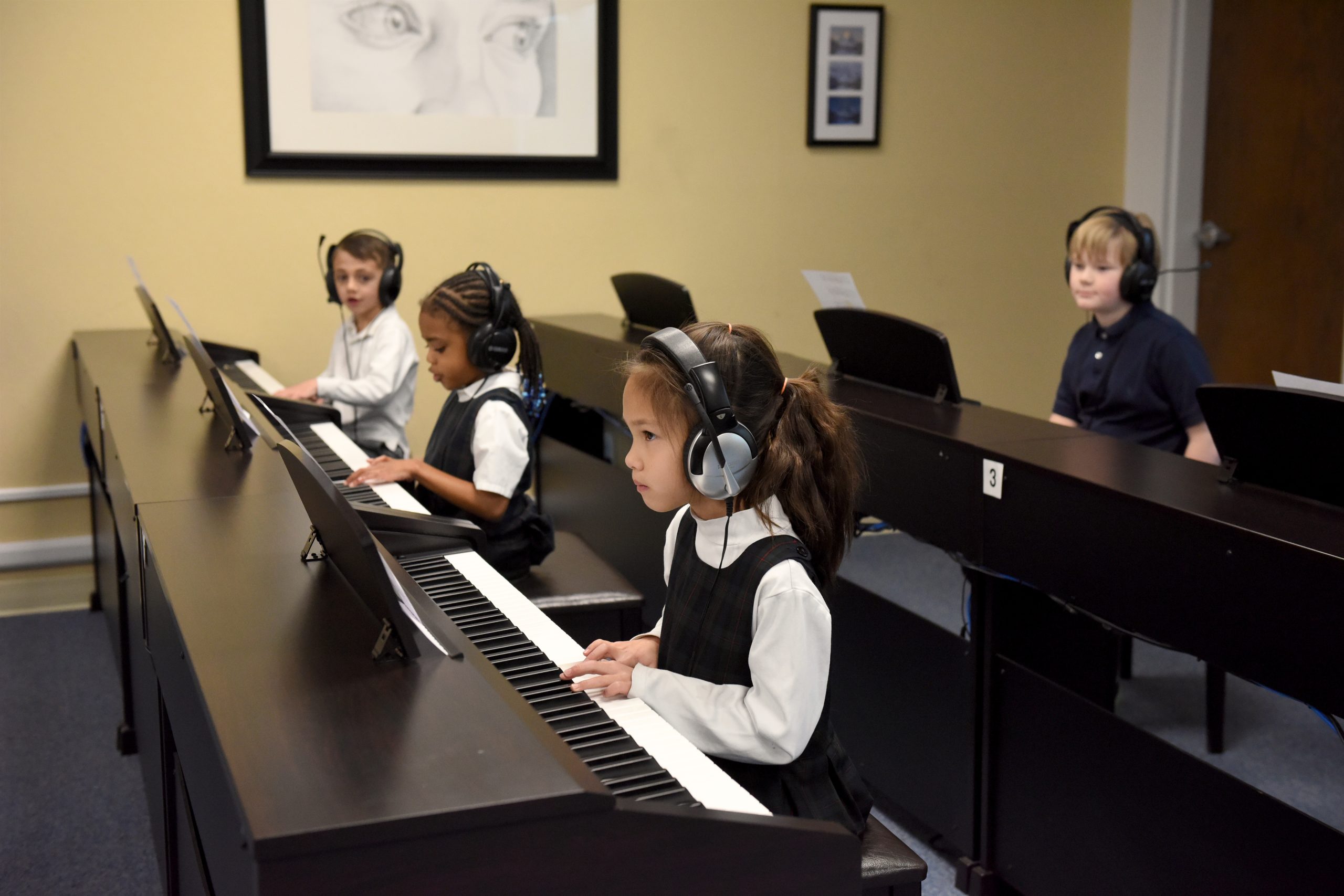 Students learn to read music on the piano with Waterford's music specialist.