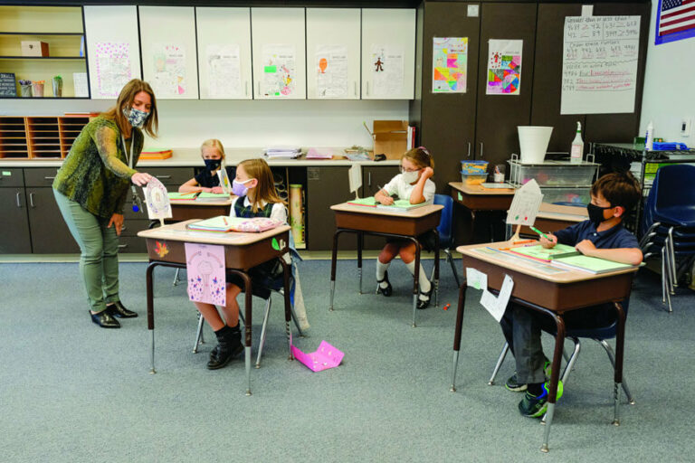 kids sitting at their desks in classroom