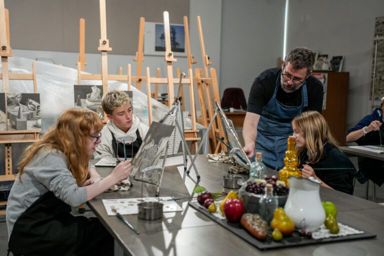 Art teacher Brant Vest helping Middle School students paint
